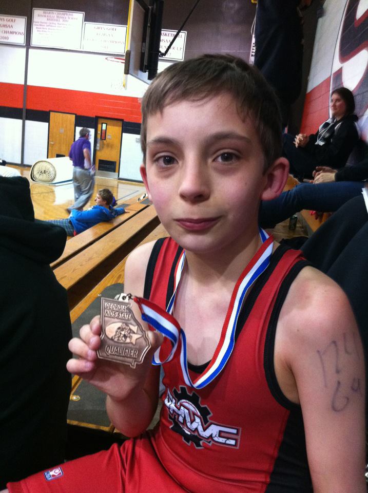 Gavin showing off his Special Olympic medal