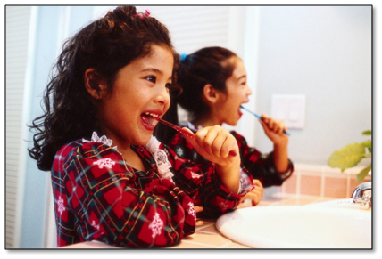 Two girls brushing teeth