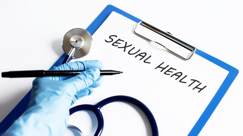 Paper with text SEXUAL HEALTH on a table with stethoscope. 