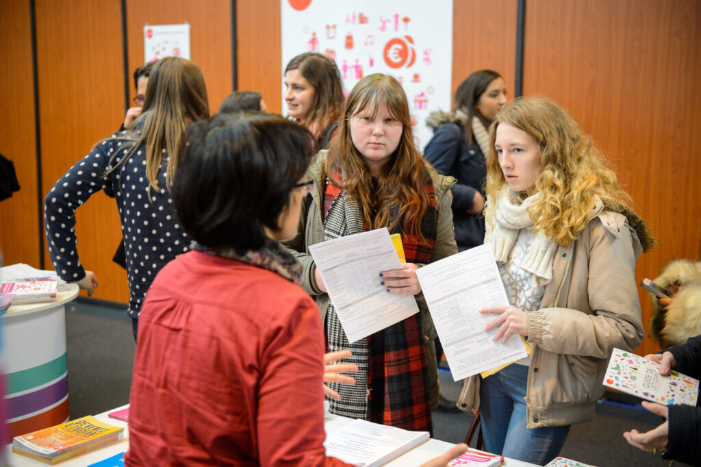 Children and teens of all ages attending annual Education Fair to choose career path and receive vocational counseling - friends receiving advice